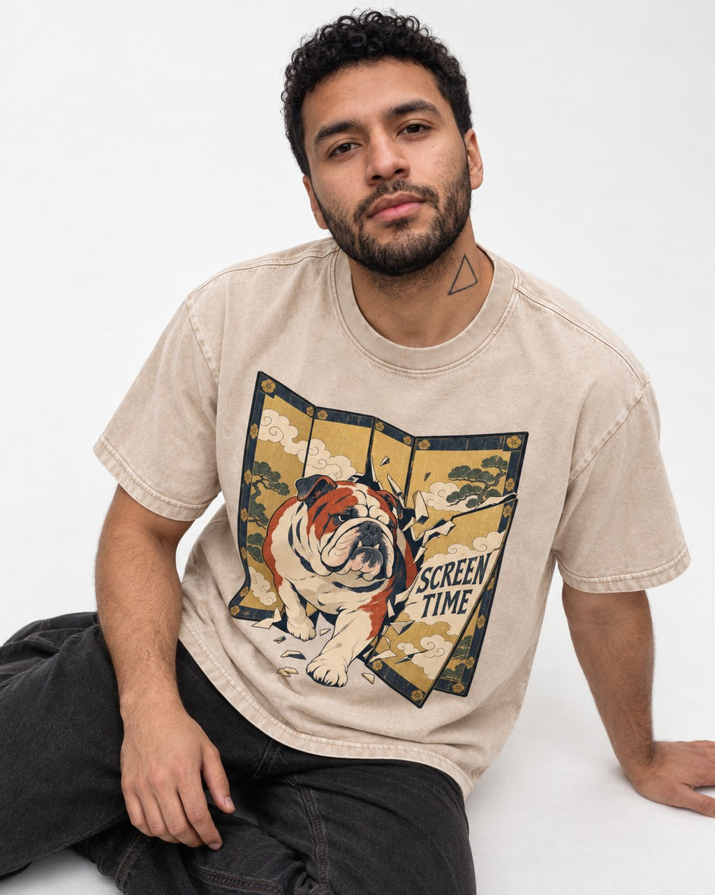 English Bulldog Screen Time Washed Tee in Apricot, worn by a seated model