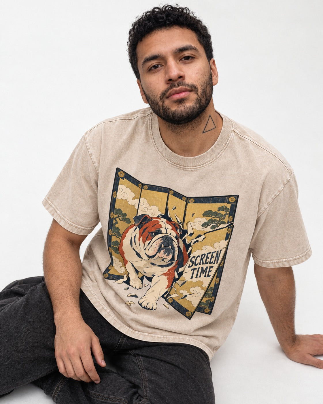 English Bulldog Screen Time Washed Tee in Apricot, worn by a seated model
