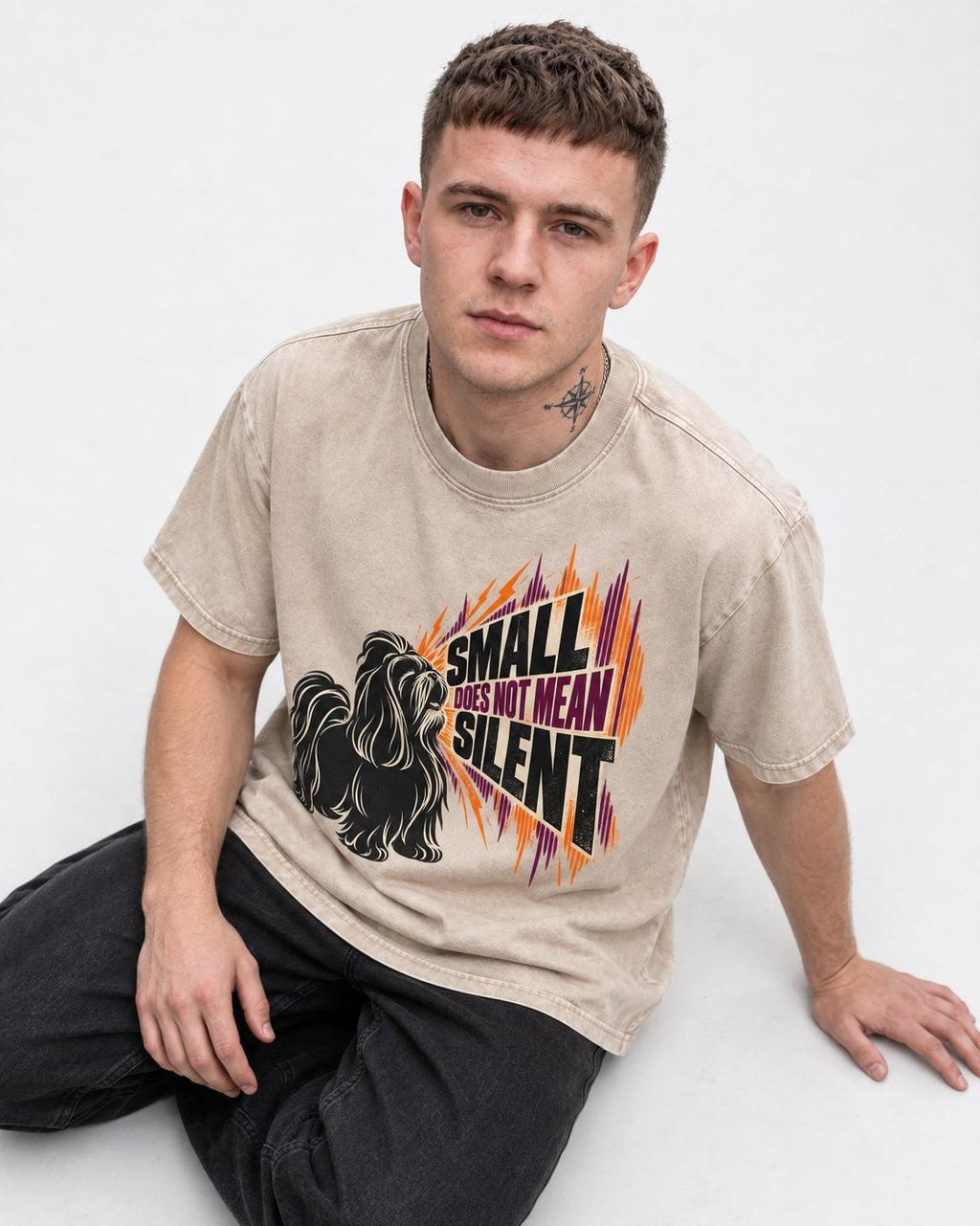 Small Not Silent Shih Tzu Washed Tee in Apricot, worn by a seated model