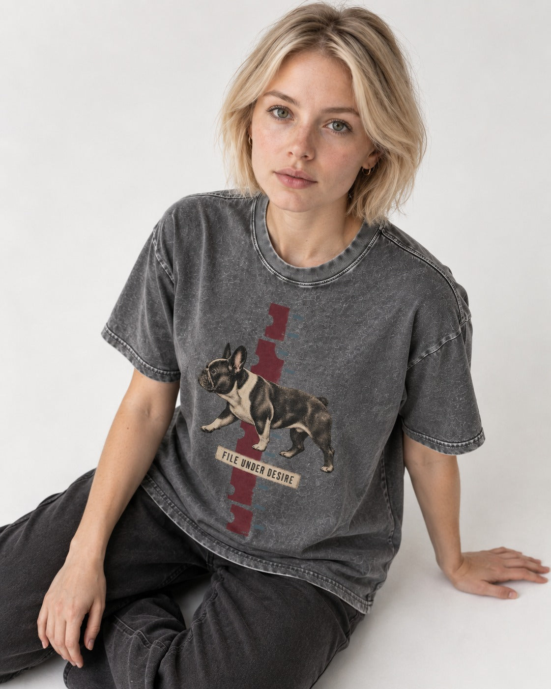 File Under Frenchie Desire Washed Tee in Gray, worn by a seated model