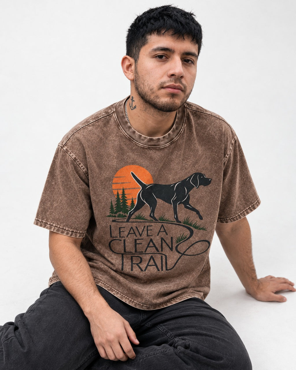 Leave a Clean Trail German Shorthaired Pointer Washed Tee in Coffee, worn by a seated model