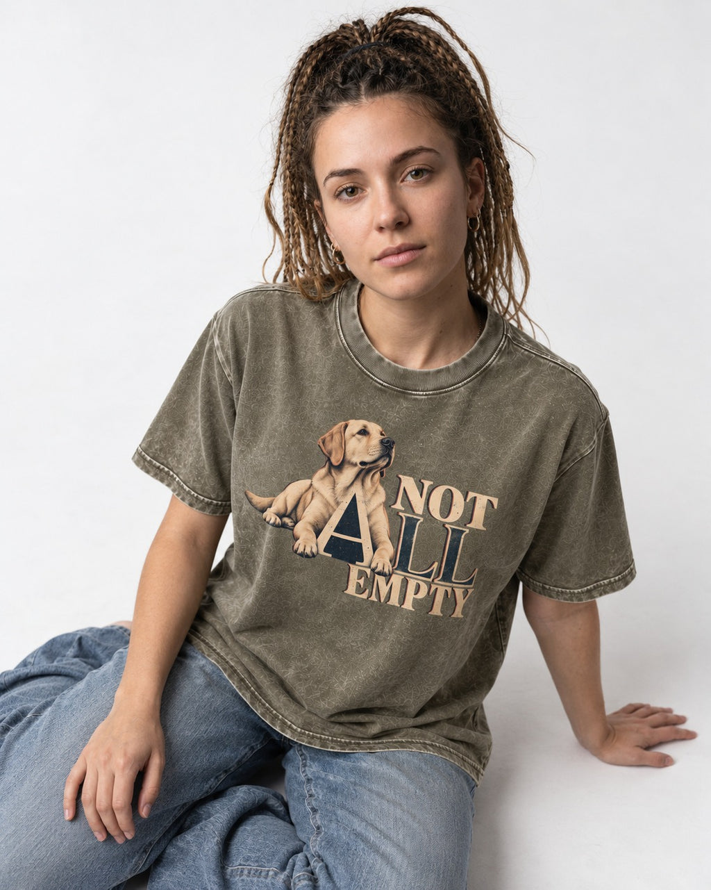 Labrador Retriever Not All Empty Lounging Typography Graphic Washed Tee in Army Green, worn by a seated model