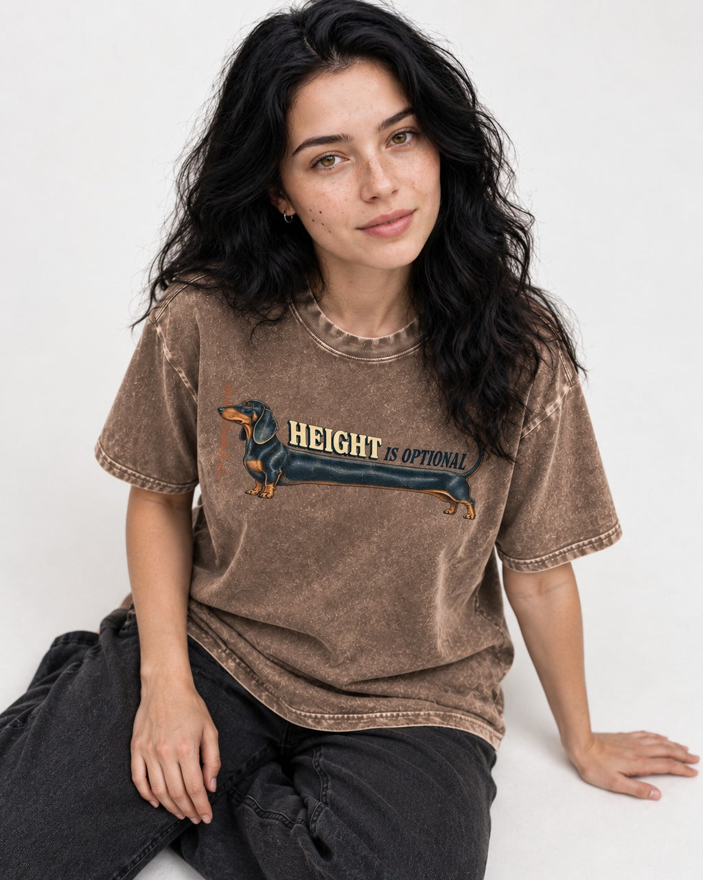 Dachshund Height Is Optional Ruler Graphic Washed Tee in Coffee, worn by a seated model