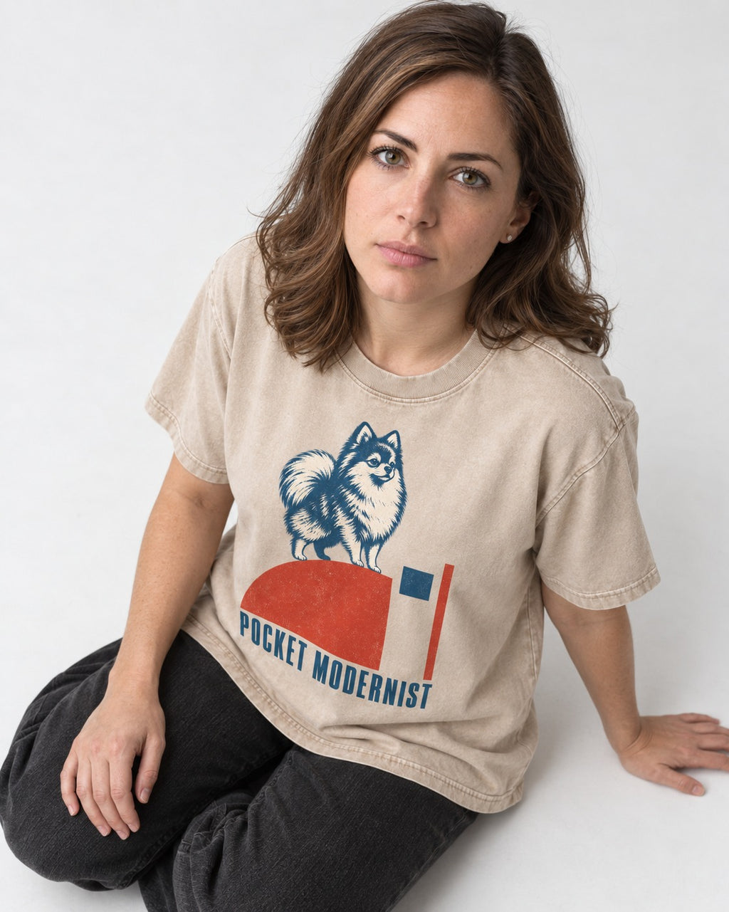 Pocket Modernist Pomeranian Washed Tee in Apricot, worn by a seated model