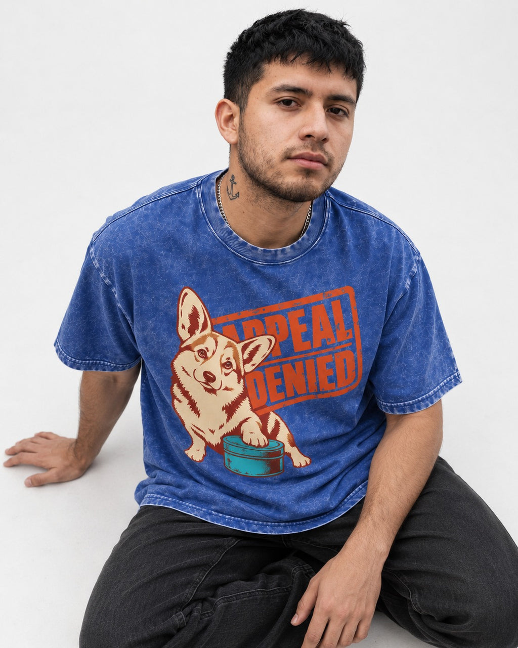 Corgi Appeal Denied Treat Tin Washed Tee in Royal Blue, worn by a seated model