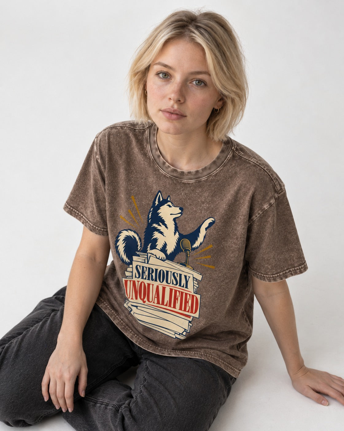 Seriously Unqualified Husky Washed Tee in Coffee, worn by a seated model