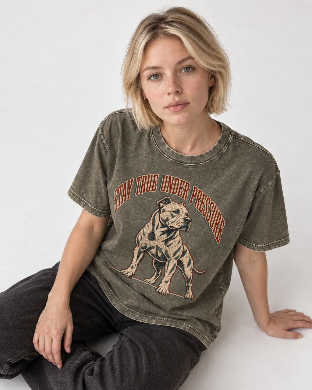 Pitbull Stay True Under Pressure Stance Graphic Washed Tee in Army Green, worn by a seated model