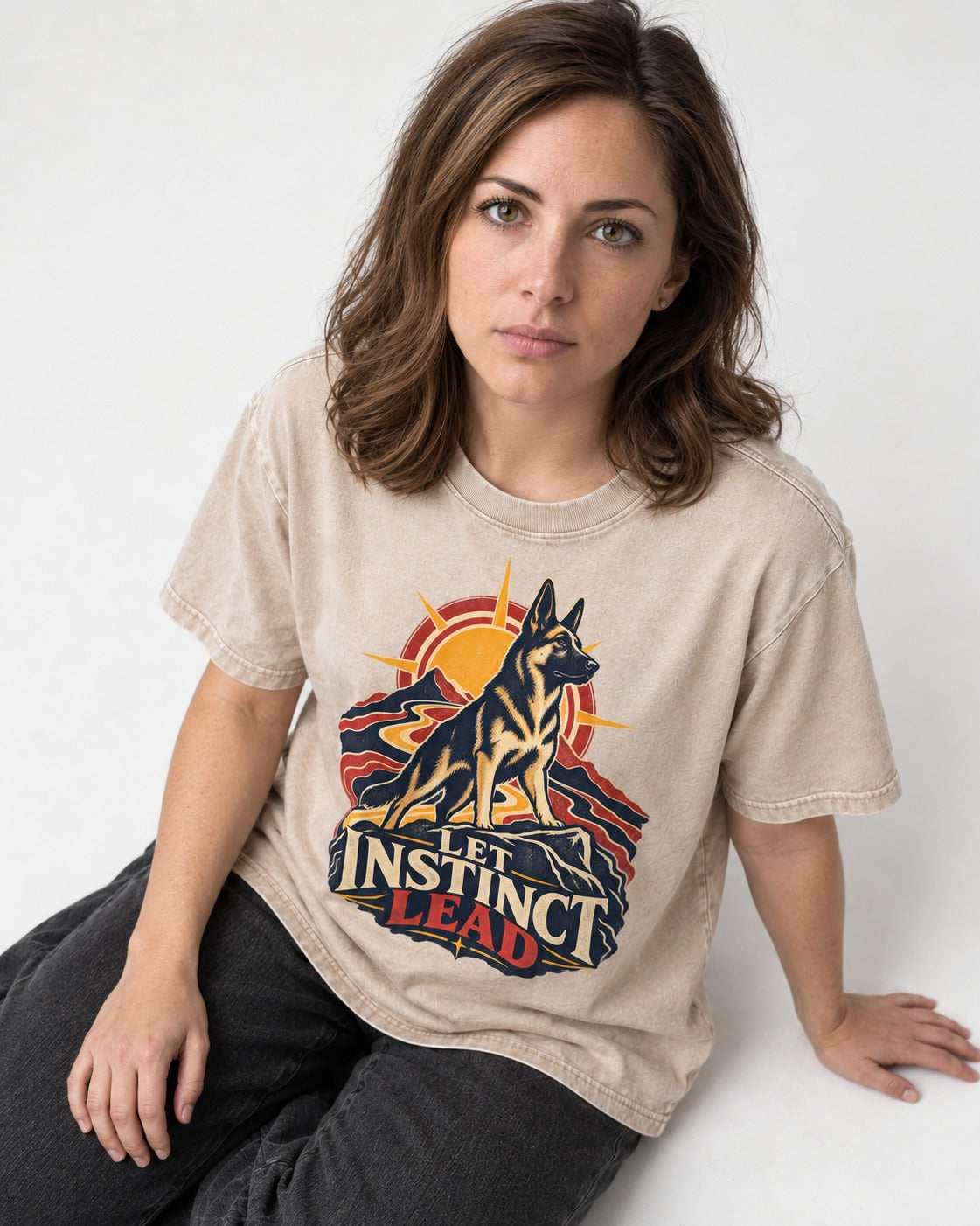 Let Instinct Lead Sunrise German Shepherd Dog Graphic Washed Tee in Apricot, worn by a seated model