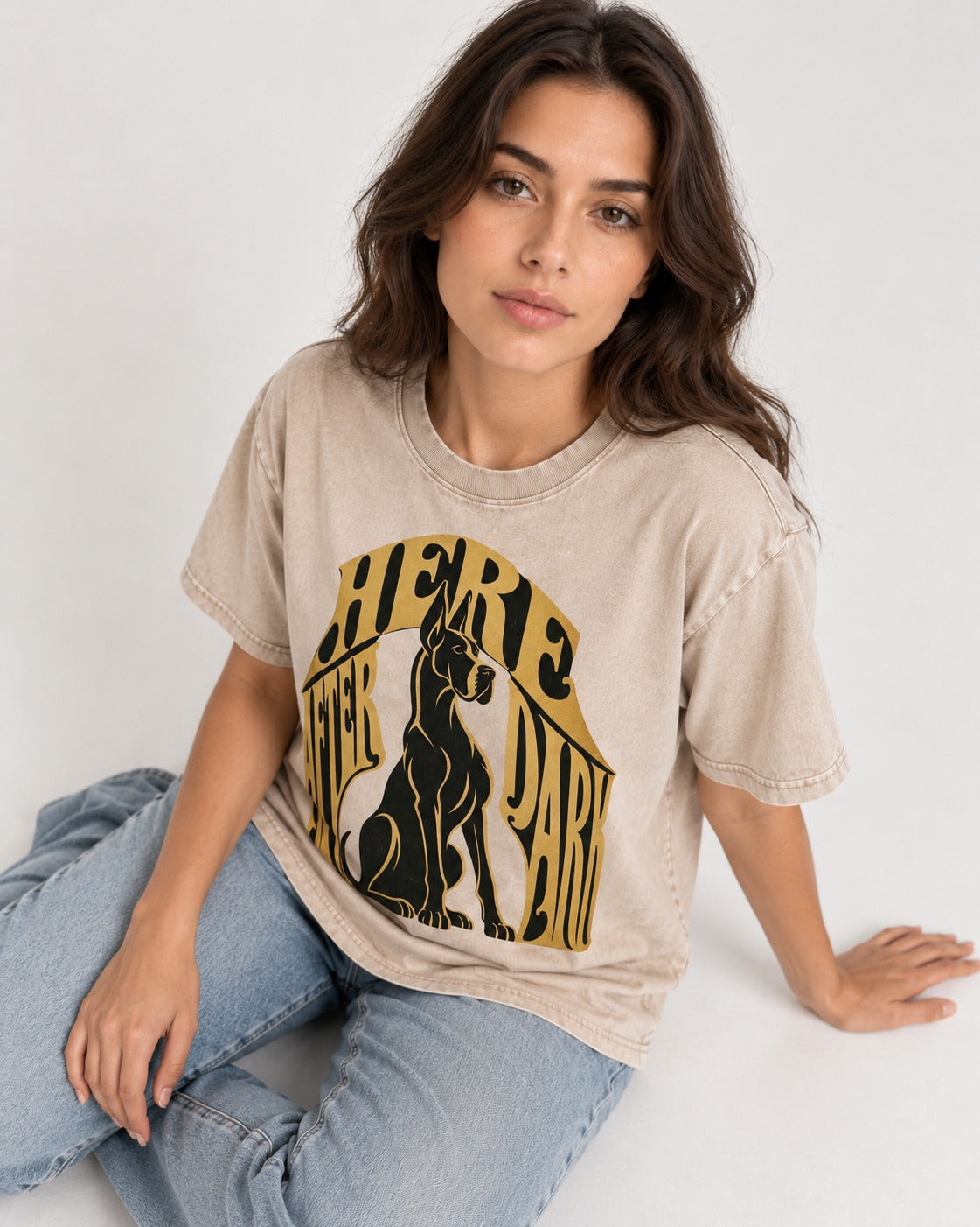 Great Dane Here After Dark Washed Tee in Apricot, worn by a seated model