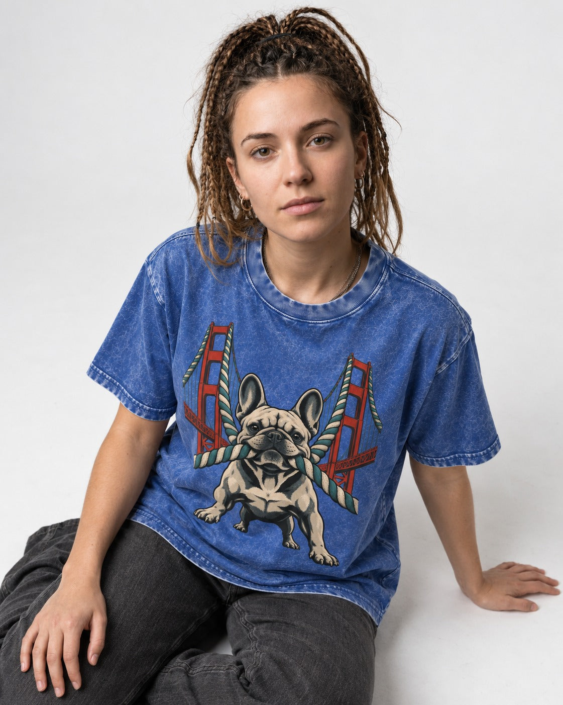 Frenchie Tug Anchor Bridge Graphic Washed Tee in Royal Blue, worn by a seated model