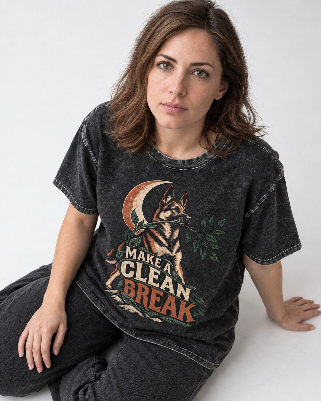 Make A Clean Break Crescent Botanical German Shepherd Dog Graphic Washed Tee in Black, worn by a seated model