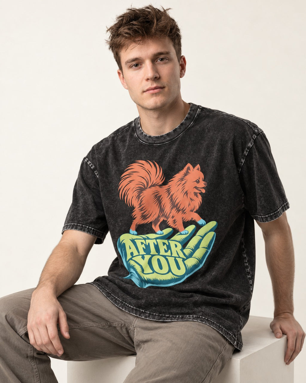 Pomeranian After You Helping Hand Graphic Washed Tee in Black, worn by a seated model