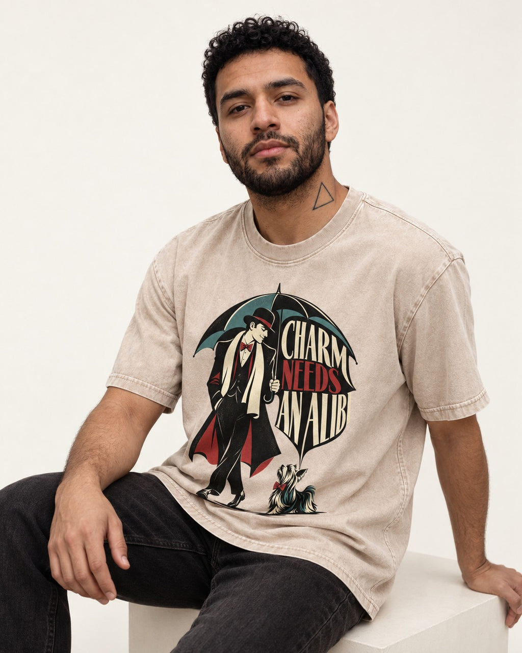 Charm Needs an Alibi Yorkshire Terrier Washed Tee in Apricot, worn by a seated model