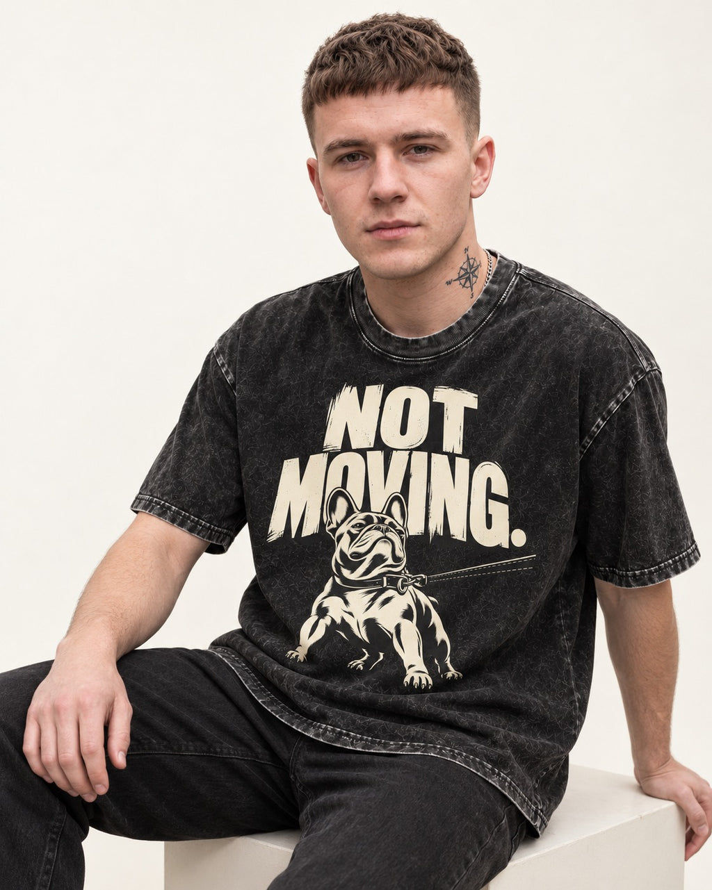 Frenchie Not Moving Taut Leash Poster Washed Tee in Black, worn by a seated model