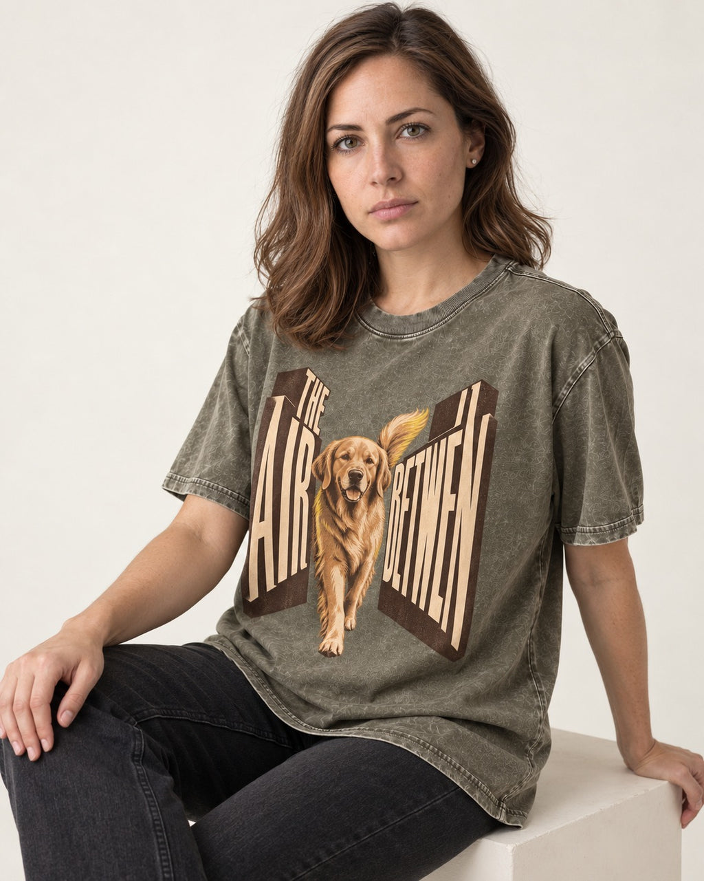 The Air Between Dimensional Golden Retriever Graphic Washed Tee in Army Green, worn by a seated model