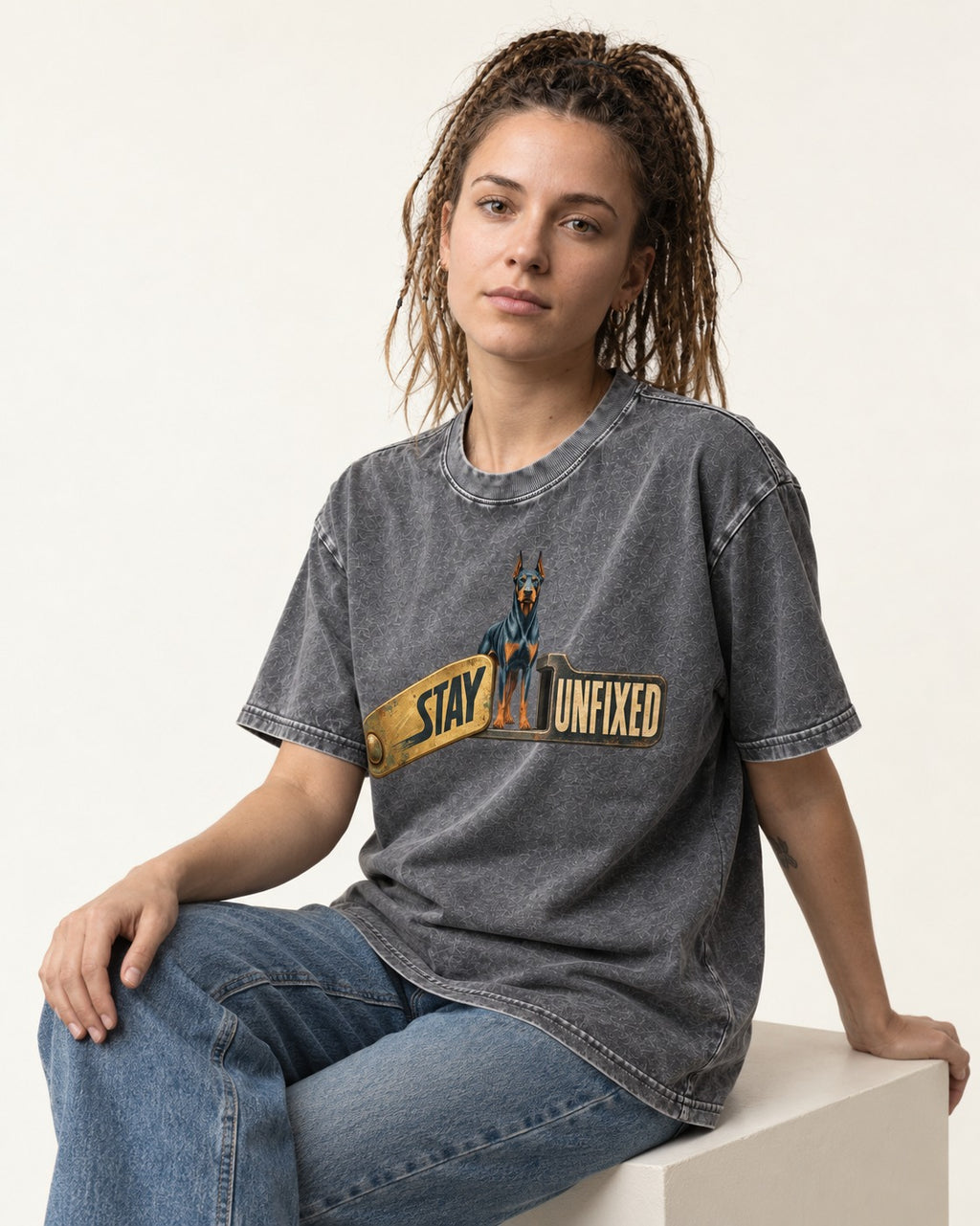 Doberman Stay Unfixed Washed Tee in Gray, worn by a seated model