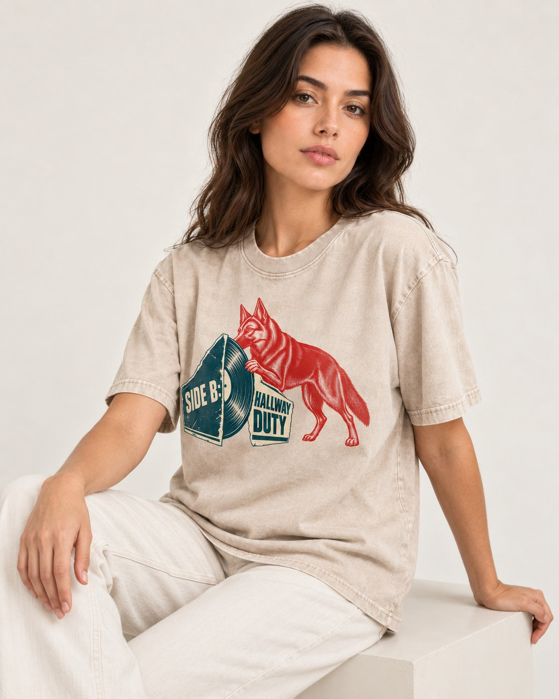 Side B Hallway Duty Vinyl Record German Shepherd Dog Graphic Washed Tee in Apricot, worn by a seated model