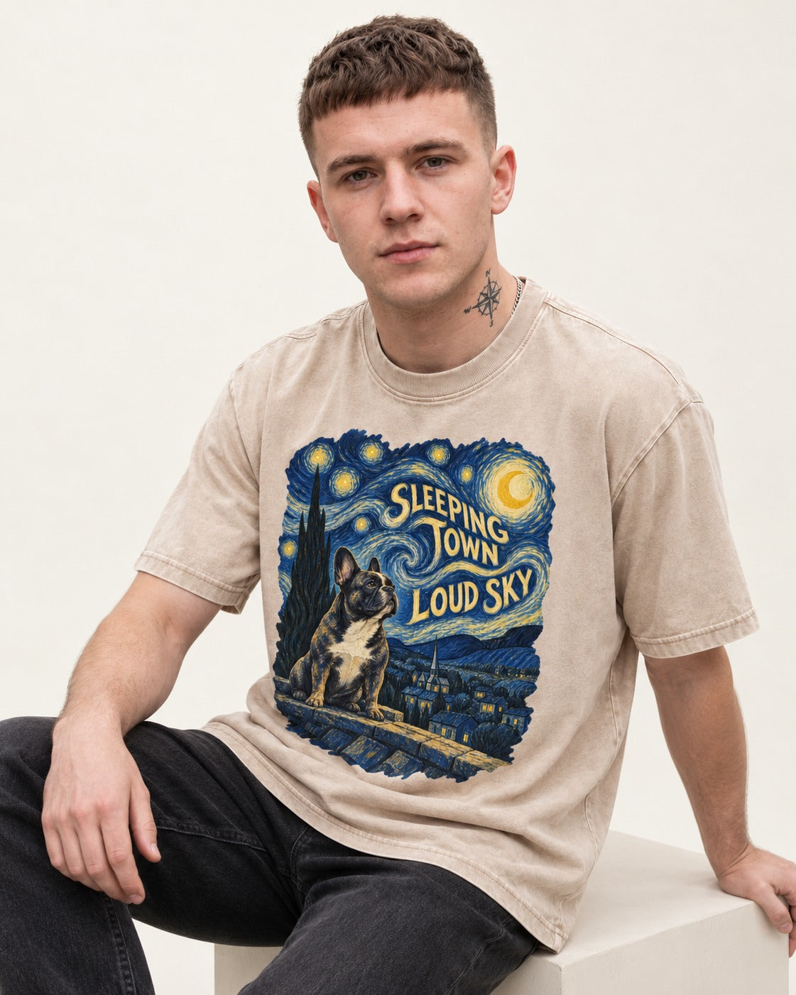 Frenchie Sleeping Town Loud Sky Rooftop Graphic Washed Tee in Apricot, worn by a seated model