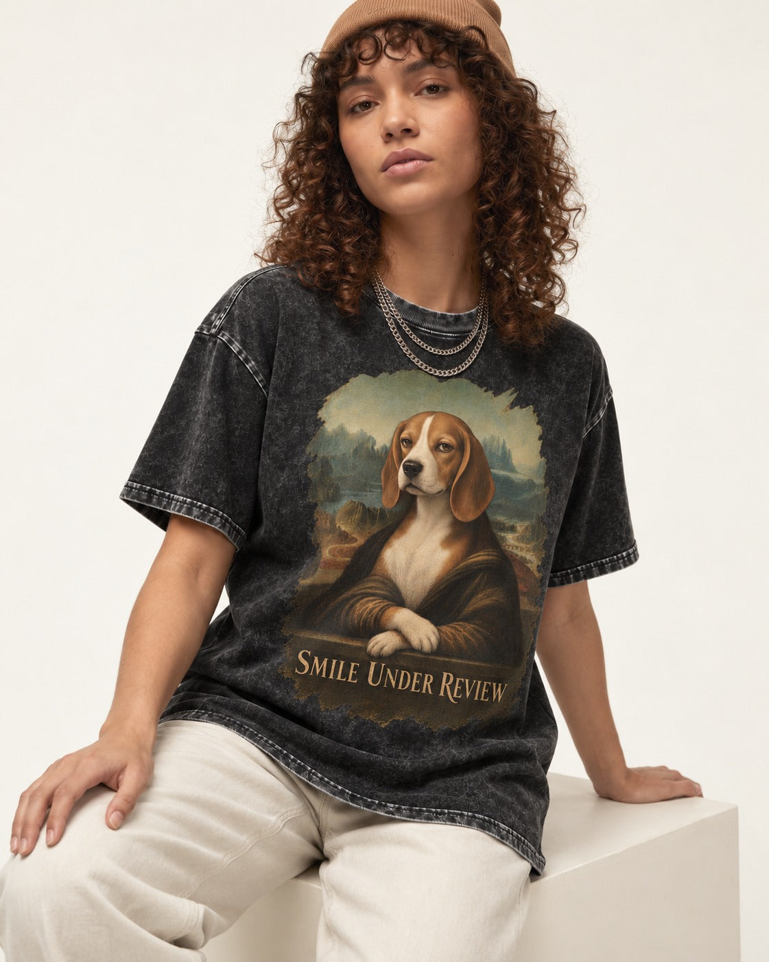 Smile Under Review Beagle Portrait Washed Tee in Black, worn by a seated model