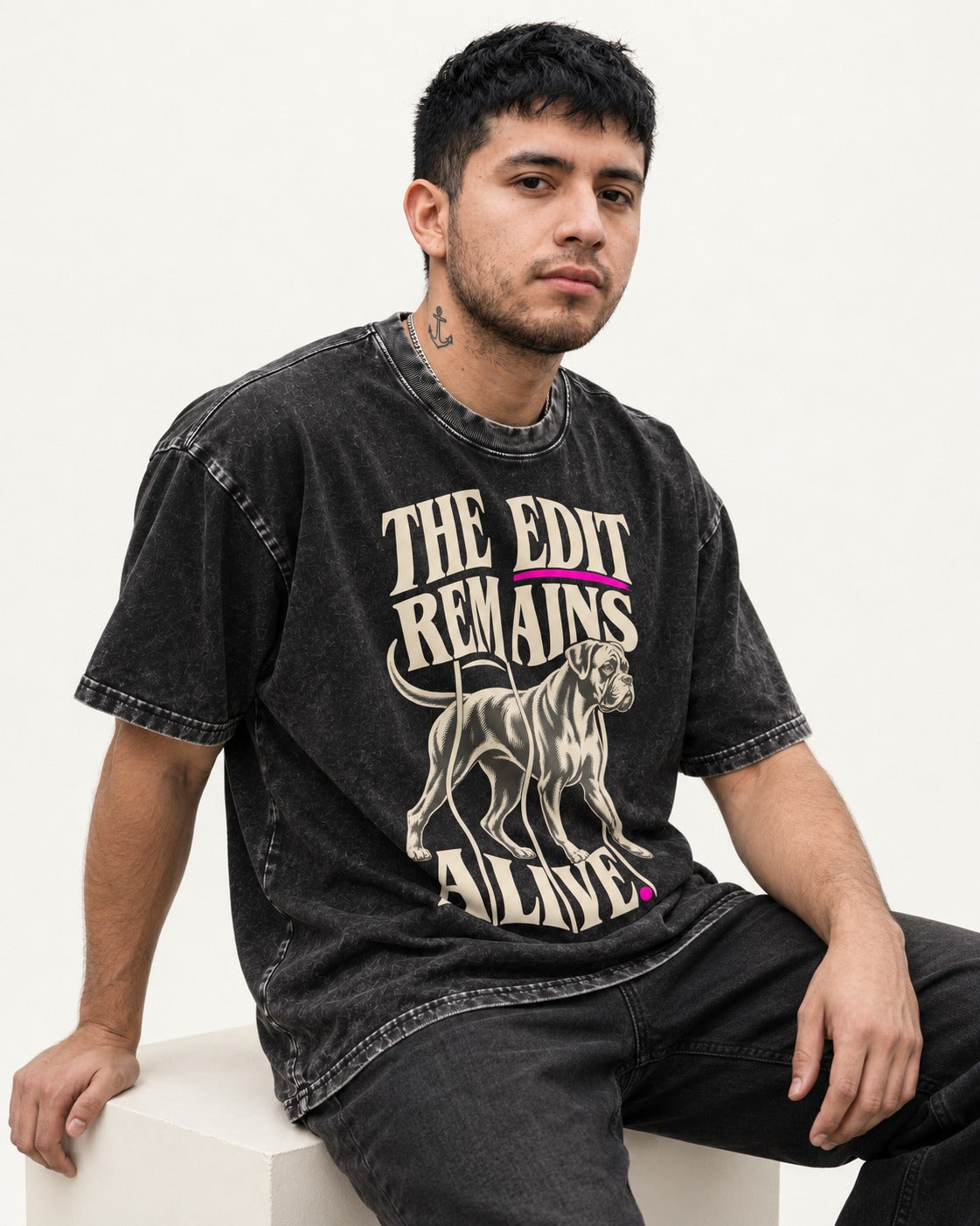 The Edit Remains Alive Boxer Washed Tee in Black, worn by a seated model