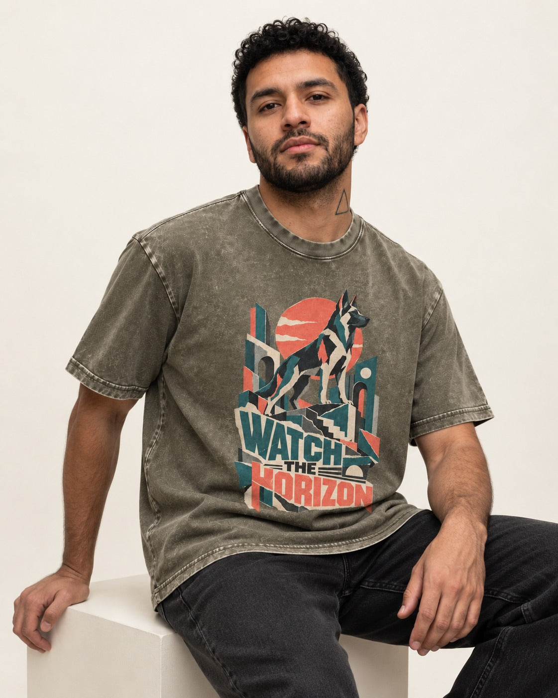Watch The Horizon Cut Paper Cityscape German Shepherd Dog Graphic Washed Tee in Army Green, worn by a seated model