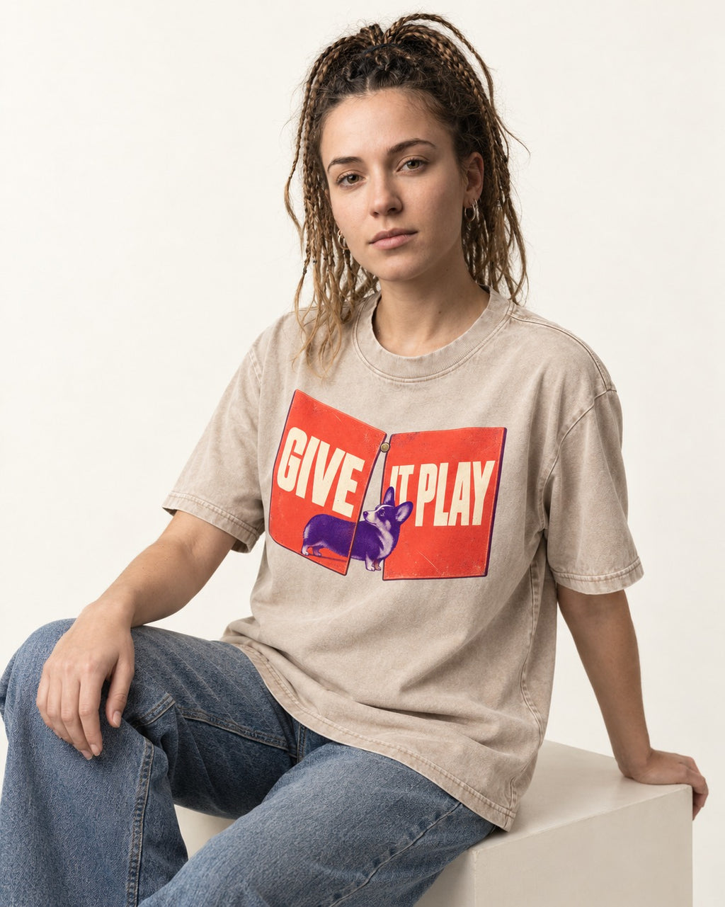 Corgi Give It Play Folding Panels Washed Tee in Apricot, worn by a seated model