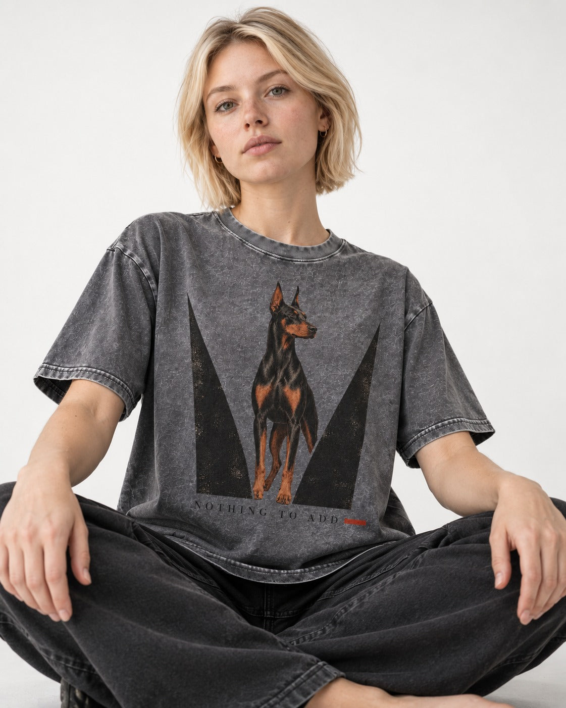 Doberman Nothing to Add Washed Tee in Gray, worn by a seated model