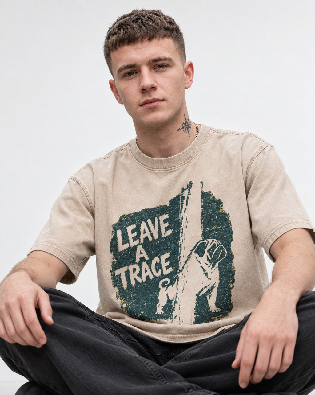 Pug Leaves a Trace Washed Tee in Apricot, worn by a seated model