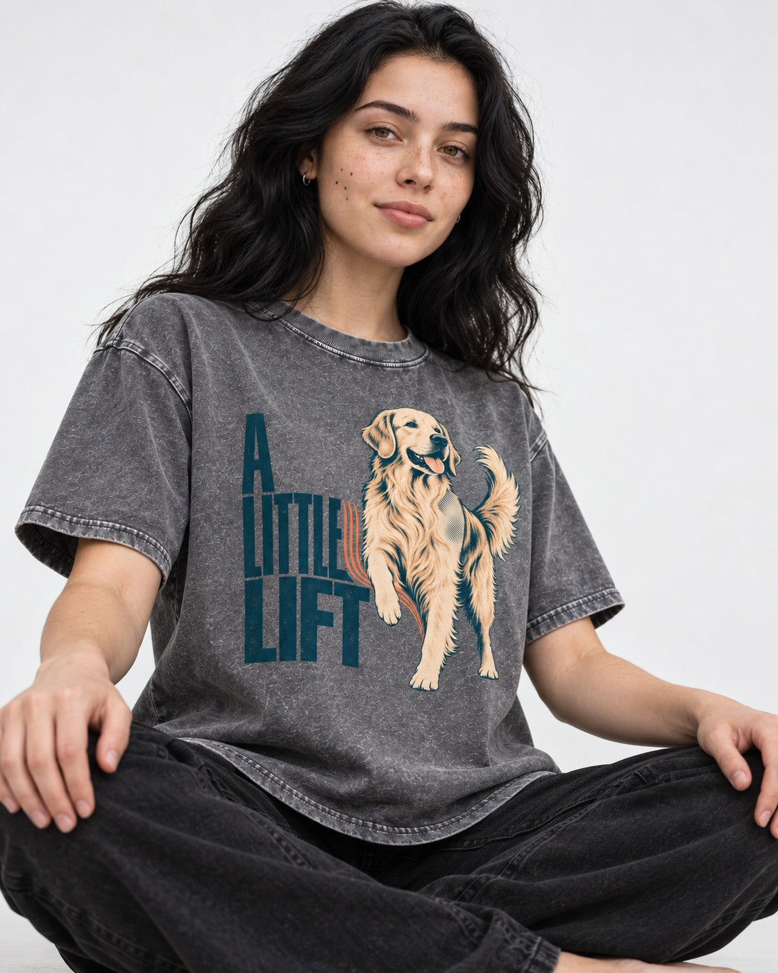 A Little Lift Golden Retriever Washed Tee in Gray, worn by a seated model