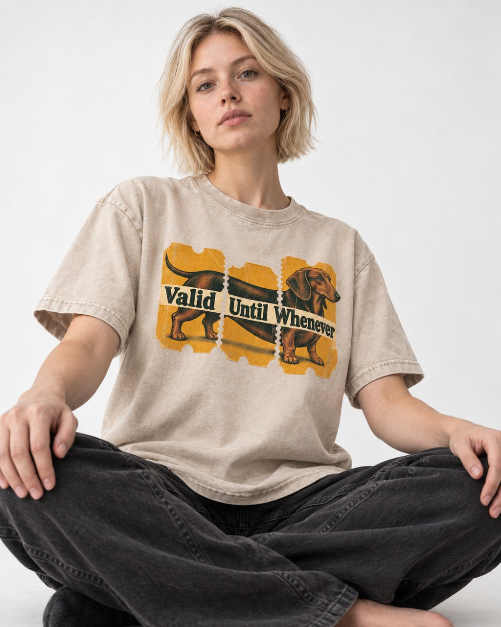 Dachshund Valid Until Whenever Washed Tee in Apricot, worn by a seated model