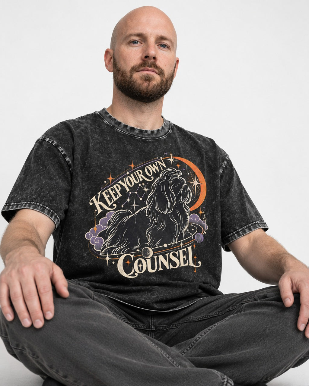 Shih Tzu Keep Your Own Counsel Celestial Graphic Washed Tee in Black, worn by a seated model