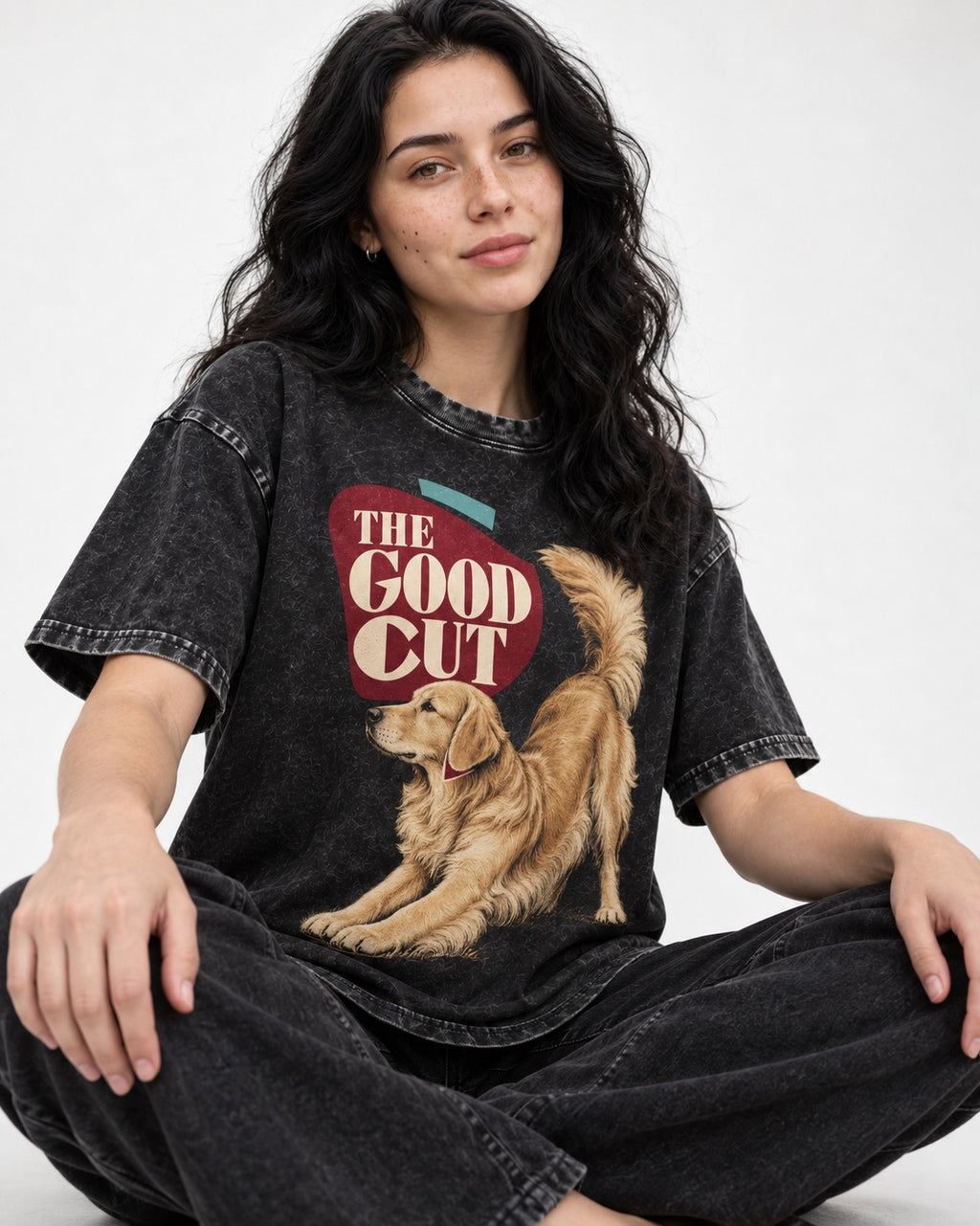 Golden Retriever The Good Cut Play Bow Graphic Washed Tee in Black, worn by a seated model
