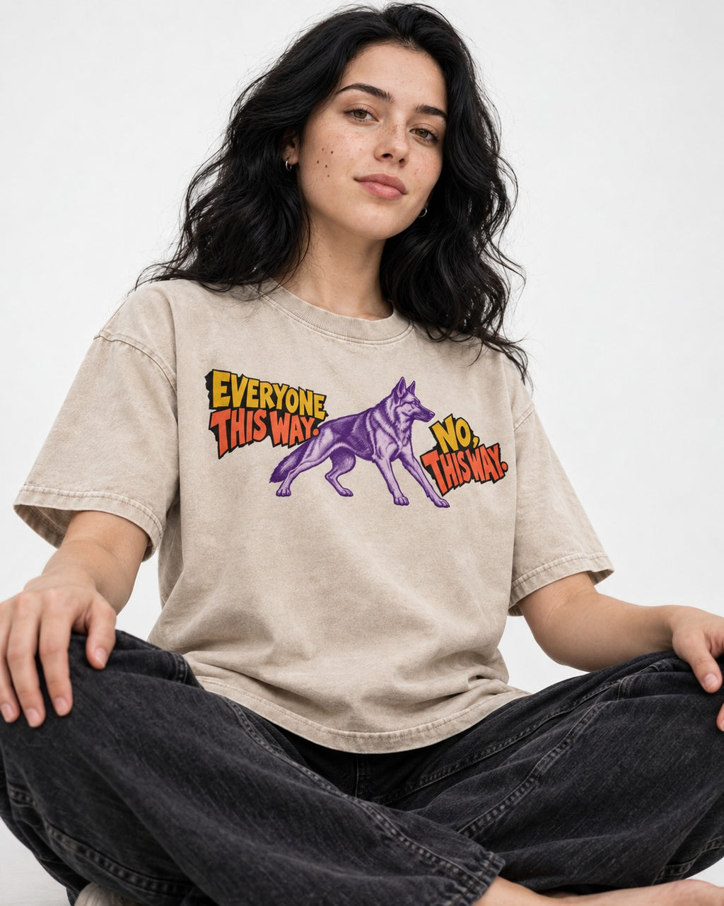 German Shepherd Dog Everyone This Way No This Way Direction Graphic Washed Tee in Apricot, worn by a seated model