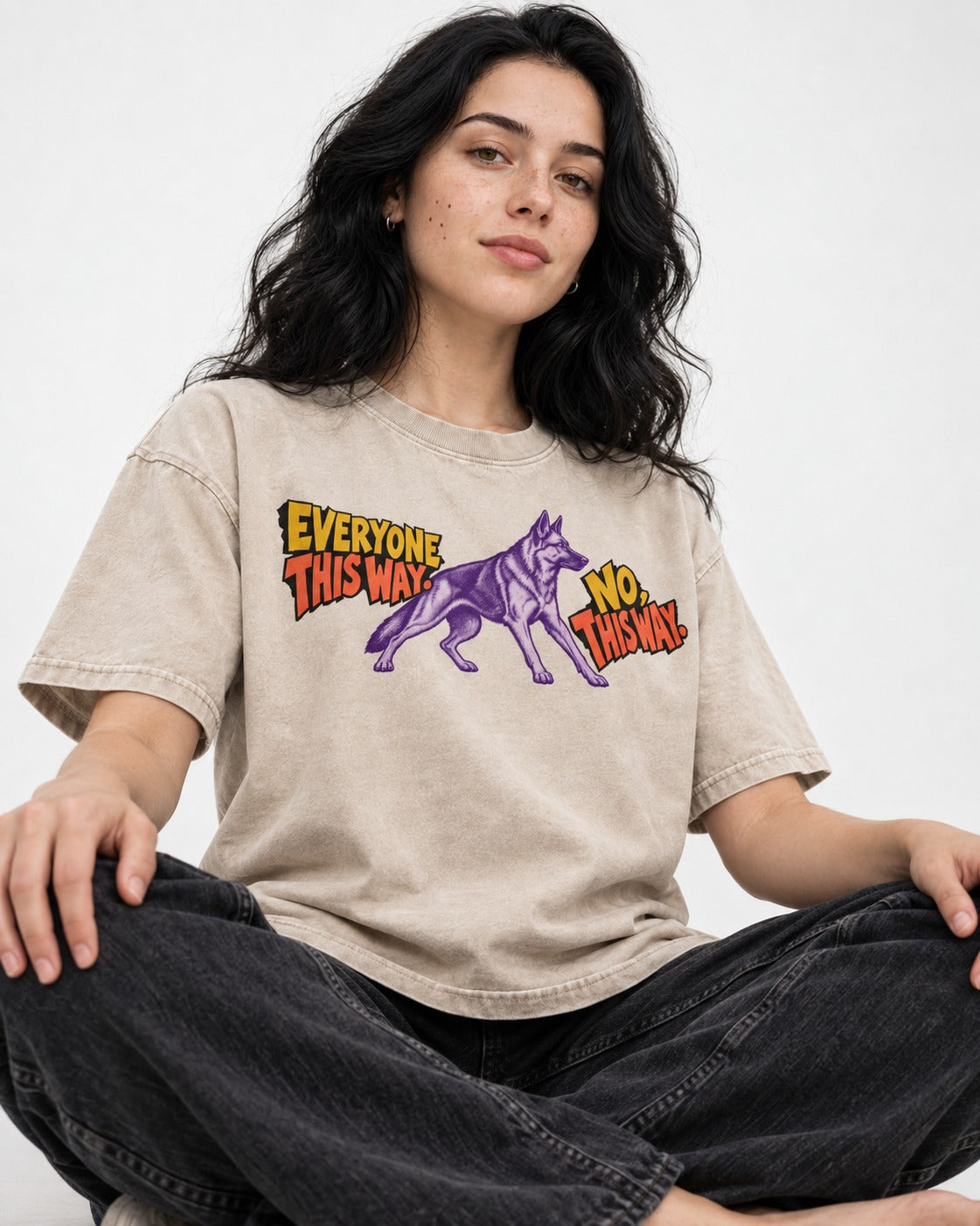 German Shepherd Dog Everyone This Way No This Way Direction Graphic Washed Tee in Apricot, worn by a seated model