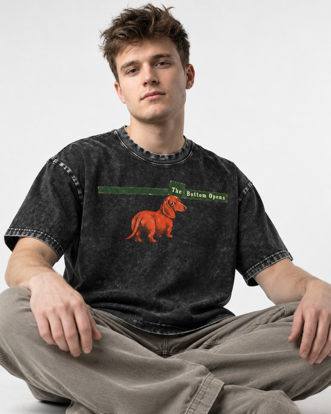 Dachshund The Bottom Opens Signpost Graphic Washed Tee in Black, worn by a seated model