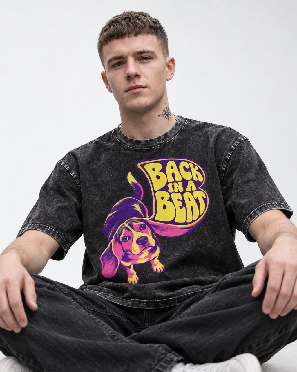 Groovy Beagle Back In A Beat Washed Tee in Black, worn by a seated model