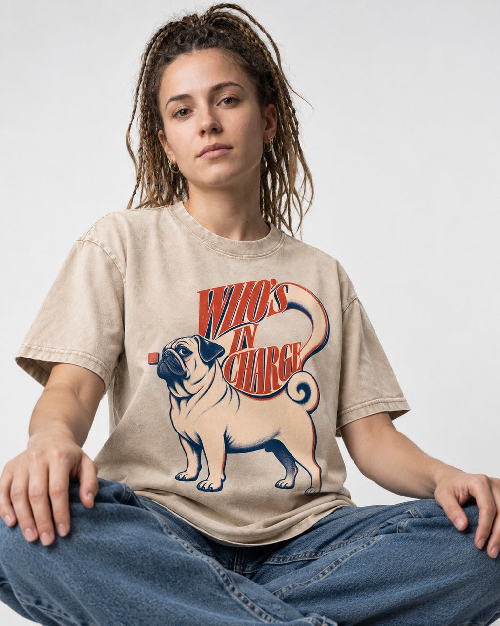 Pug In Charge Washed Tee in Apricot, worn by a seated model