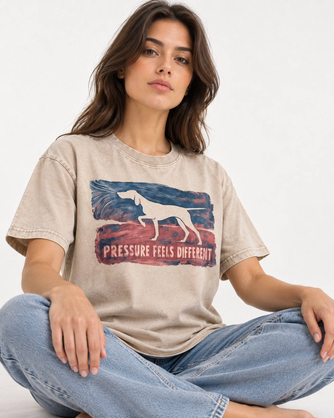 German Shorthaired Pointer Pressure Feels Different Monotype Graphic Washed Tee in Apricot, worn by a seated model