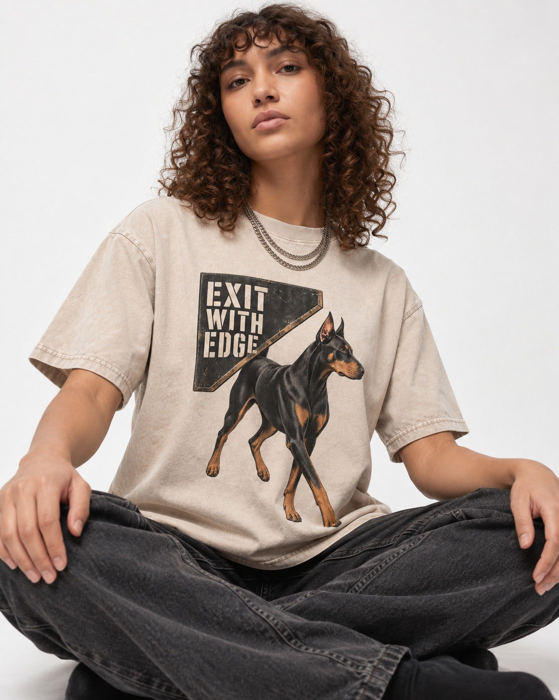 Exit with Doberman Edge Washed Tee in Apricot, worn by a seated model