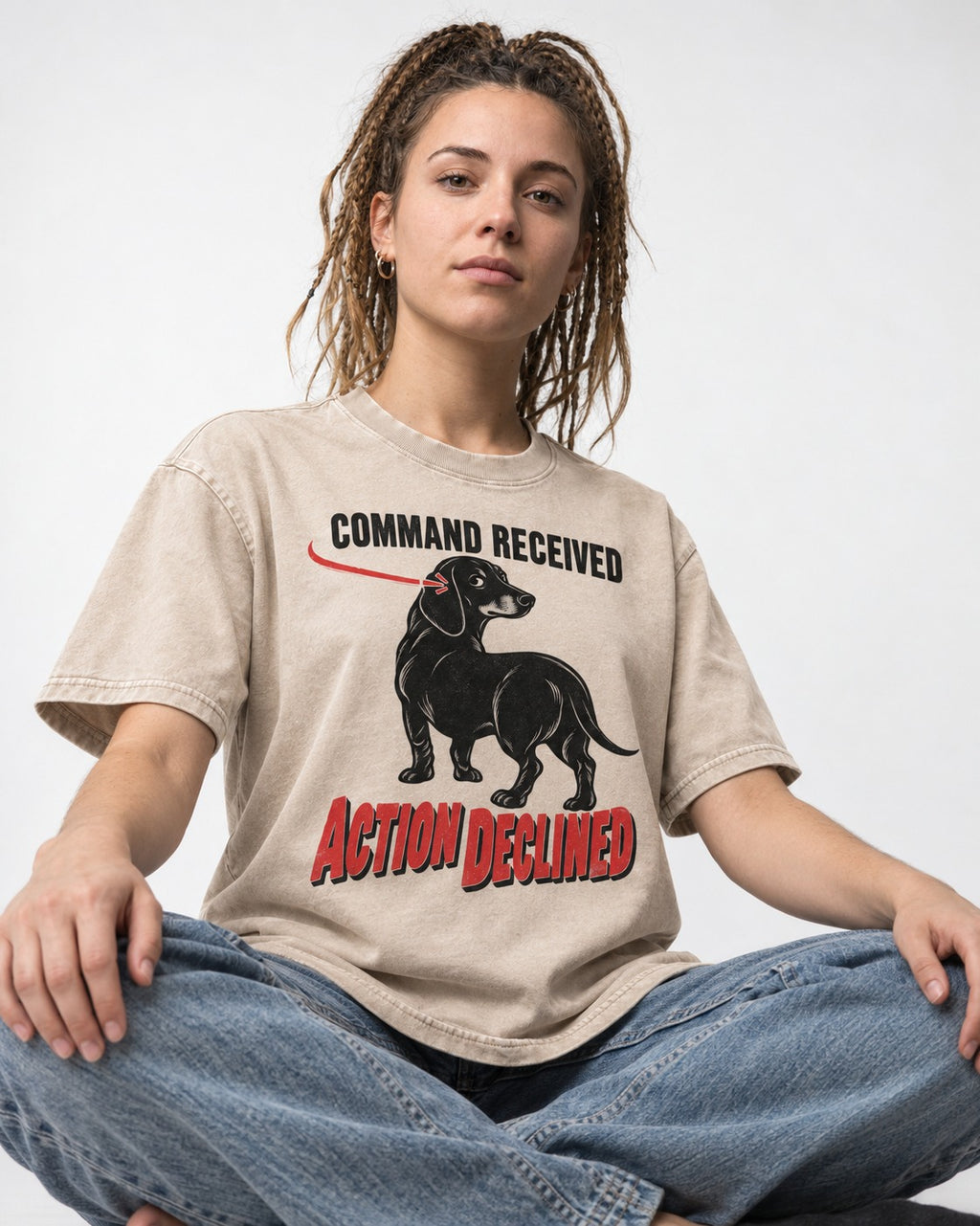 Dachshund Action Declined Washed Tee in Apricot, worn by a seated model