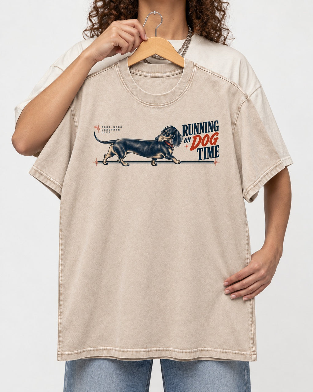 Dachshund Lengthens Life Washed Tee in Apricot, held up on a hanger
