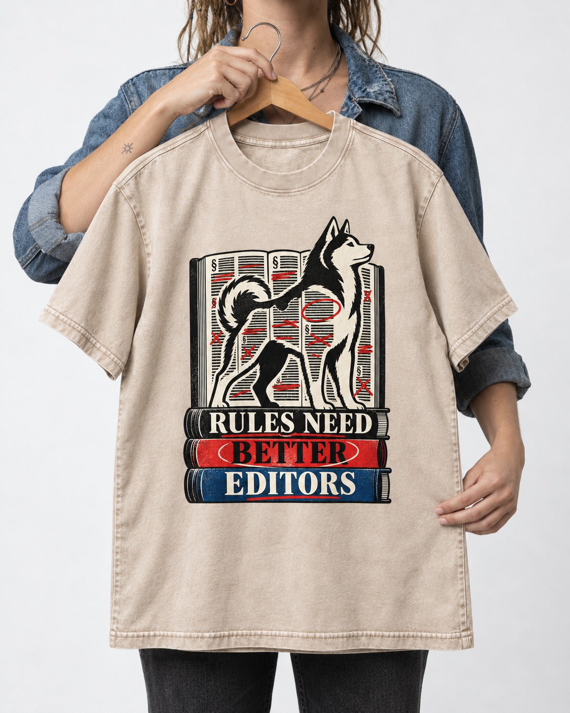 Husky Rules Need Better Editors Book Stack Graphic Washed Tee in Apricot, held up on a hanger