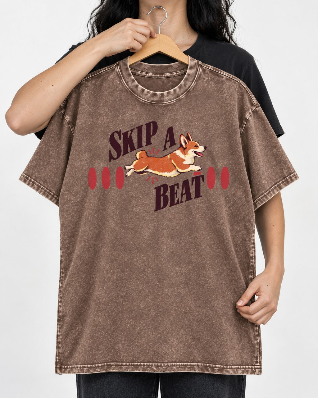 Skip a Beat Corgi Washed Tee in Coffee, held up on a hanger