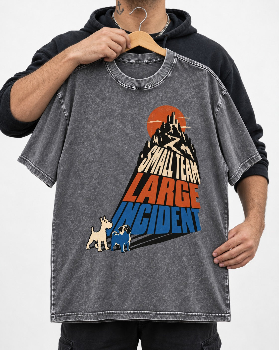 Pug Small Team Large Incident Mountain Graphic Washed Tee in Gray, held up on a hanger