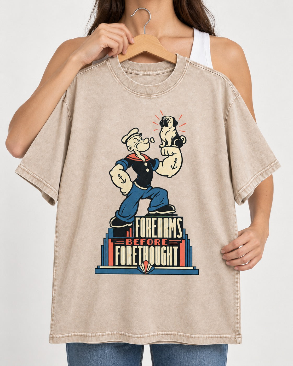 Pug Forearms Before Forethought Washed Tee in Apricot, held up on a hanger