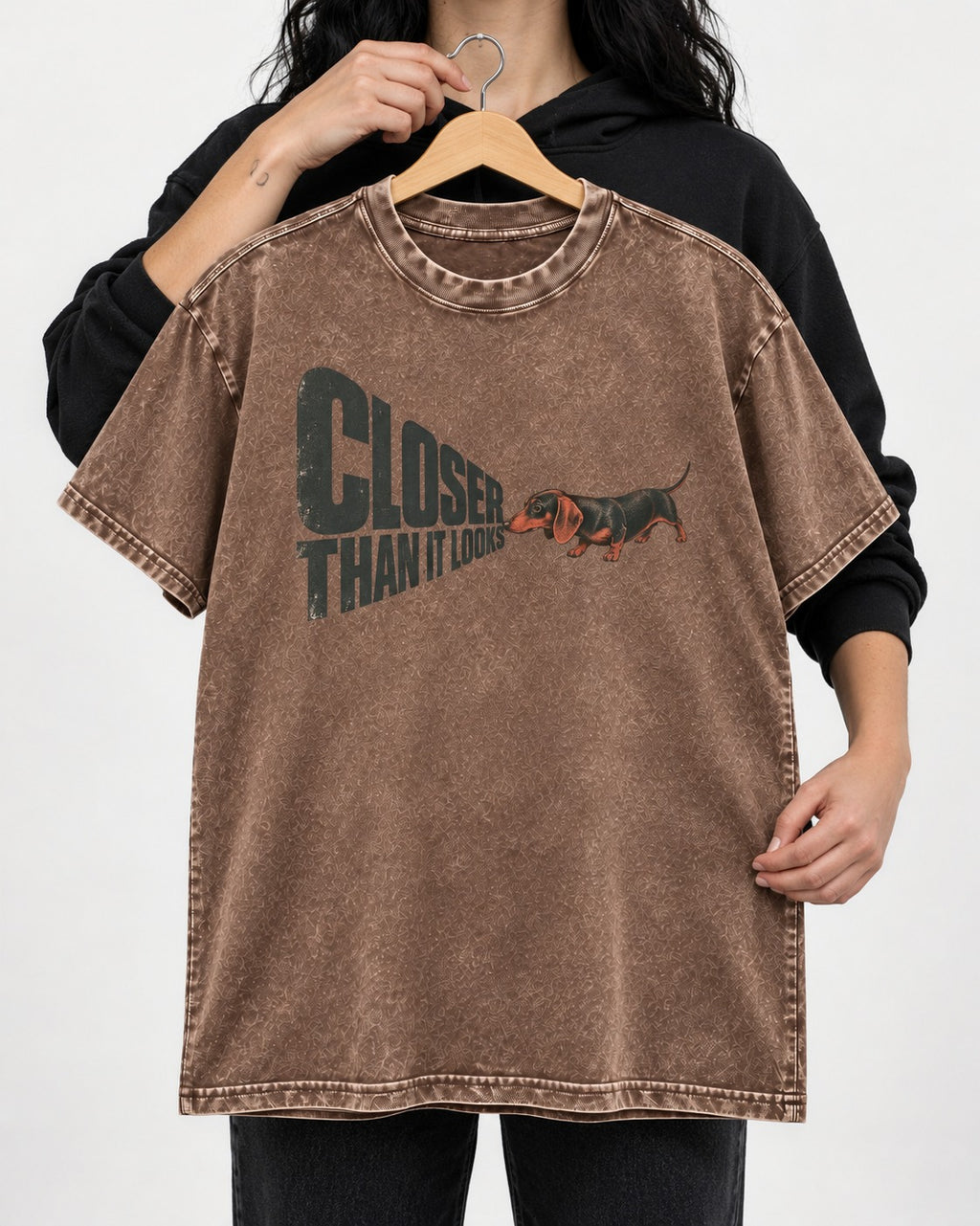 Dachshund Closer Than It Looks Washed Tee in Coffee, held up on a hanger