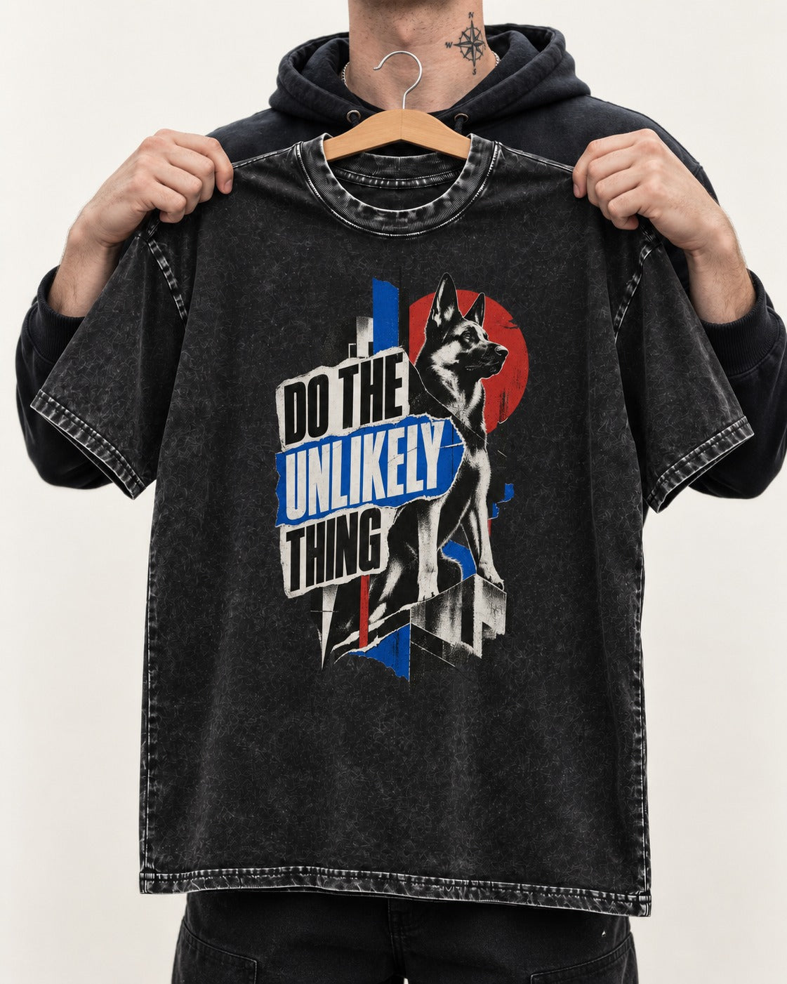 Do The Unlikely Thing Torn Poster German Shepherd Dog Graphic Washed Tee in Black, held up on a hanger