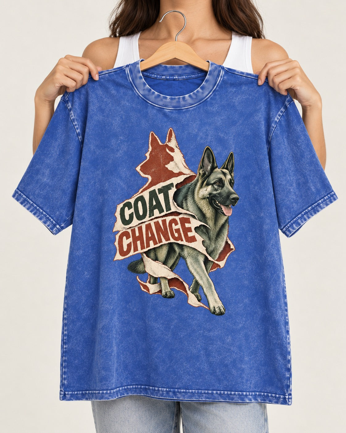 Coat Change Running German Shepherd Dog Ribbon Graphic Washed Tee in Royal Blue, held up on a hanger