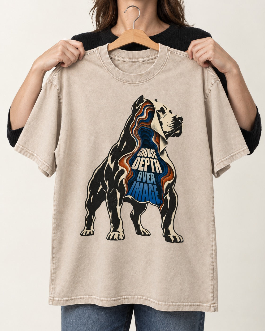 Pitbull Choose Depth Over Image Layered Cutaway Graphic Washed Tee in Apricot, held up on a hanger