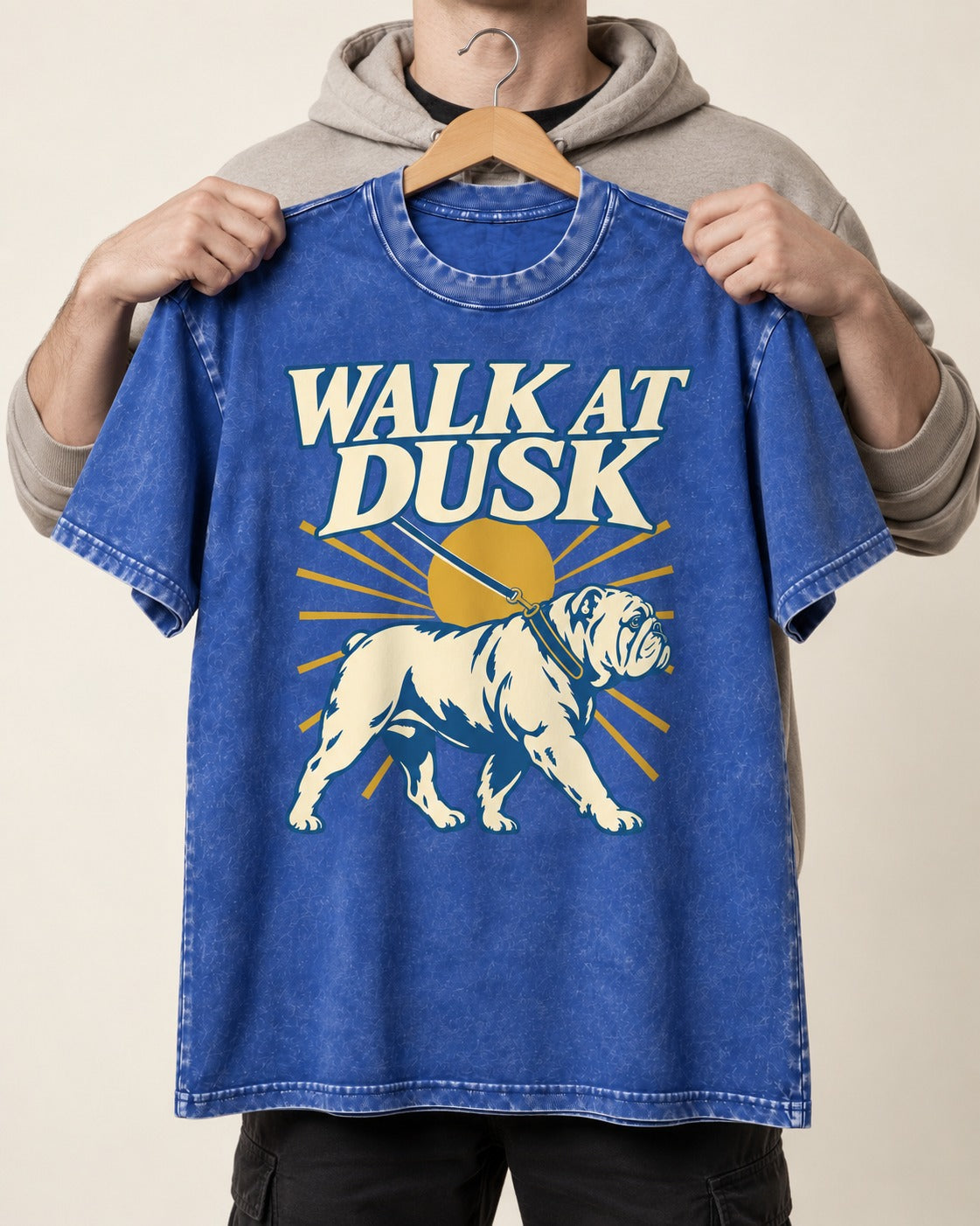 English Bulldog Walk at Dusk Sunset Graphic Washed Tee in Royal Blue, held up on a hanger